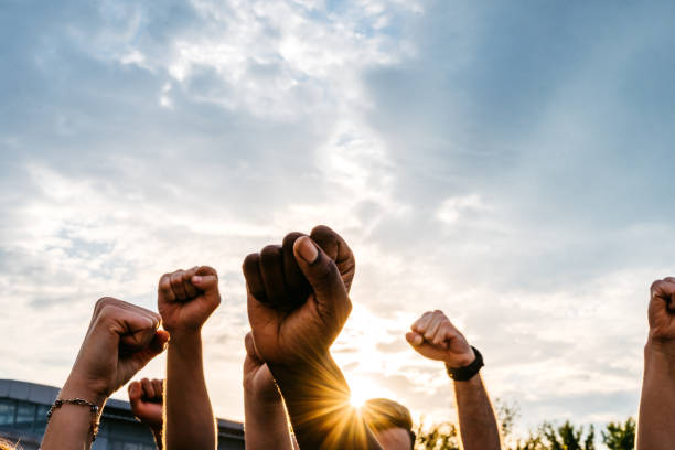istock Protestors raising fists 1271122671