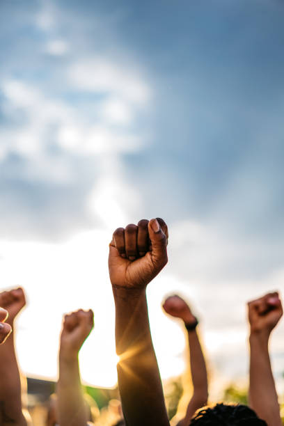 istock Protestors raising fists 1271122714