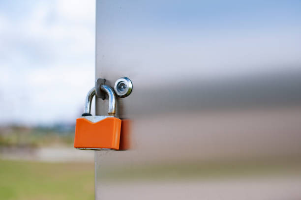 A padlock hangs on a metal door