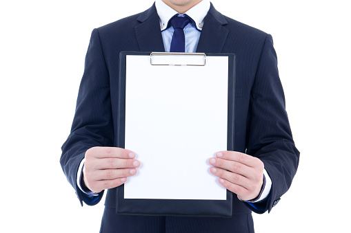 blank clipboard in young businessman's hands isolated on white background