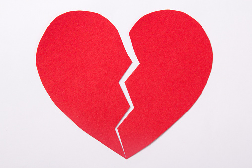 love concept - red paper broken heart over white background