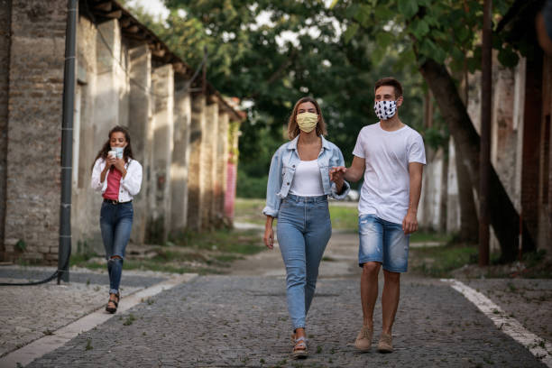 istock Keeping the social distance and wearing a protective face mask when walking 1271126567
