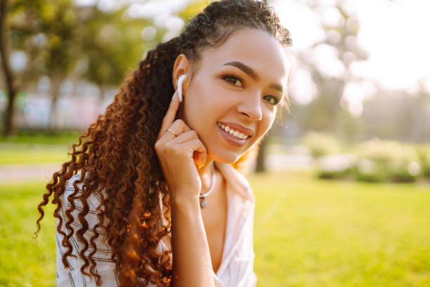 istock Young woman with wireless headphones at sunset. 1271127764