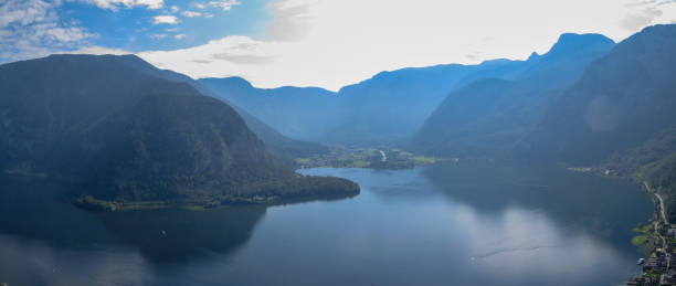 istock Panoramic view of lake surrounded by mountain ranges 1271129603
