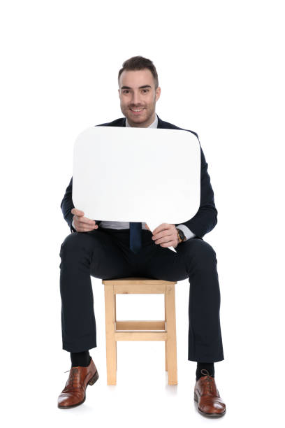 istock Happy businessman smiling and holding speech bubble 1271129768