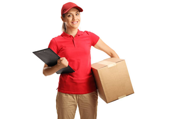 istock Woman delivery worker holding a clipboard and a box 1271131084