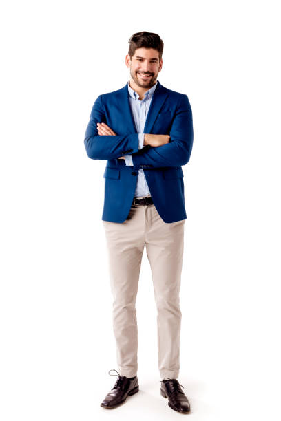 Confident businessman full length shot at isolated background Full length shot of happy businessman wearing business casual clothes while standing with arms crossed at isolated white background. blazer jacket stock pictures, royalty-free photos & images