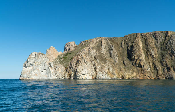 istock Cape Sagan-Khushun, rocky coast. called as the Cape Three brothers. Three stone peaks symbolizing the three brothers. concept of travel. Beautiful landscape of Siberian Baikal Lake. 1271131491