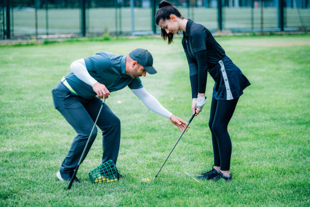 istock Individual golf lesson. Young woman having a golf lesson with golf instructor 1271132485