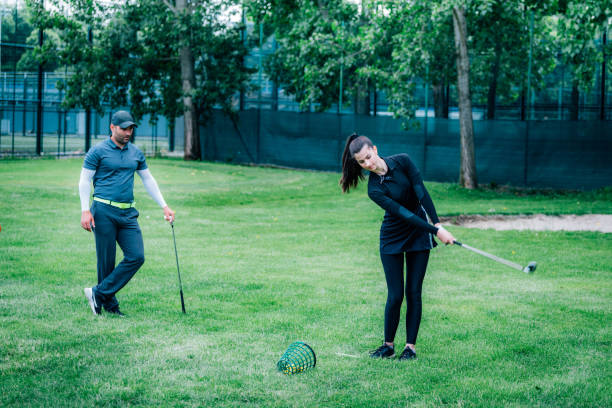 istock Individual golf lesson. Young woman having a golf lesson with golf instructor 1271132557