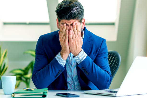 istock Overworked businessman portrait while sitting at office desk 1271132899