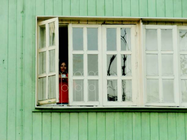istock Woman Standing at Window 1271133795