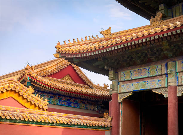 istock curved roofs with gold patterns in traditional Chinese style with ceramic figures on the blue sky background. The Imperial Palace in Beijing. 1271133802