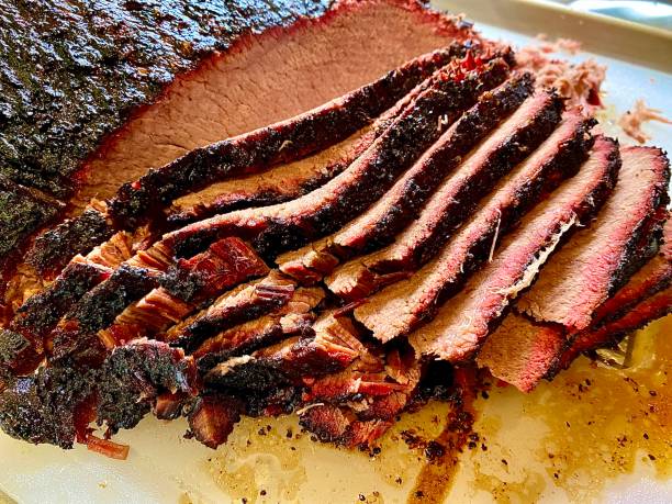 Whole Beef Brisket-Sliced Whole beef brisket being sliced. smoked stock pictures, royalty-free photos & images