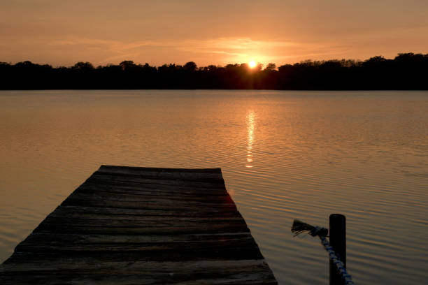istock Guatemala: sunset at lake with jetty 1271138370