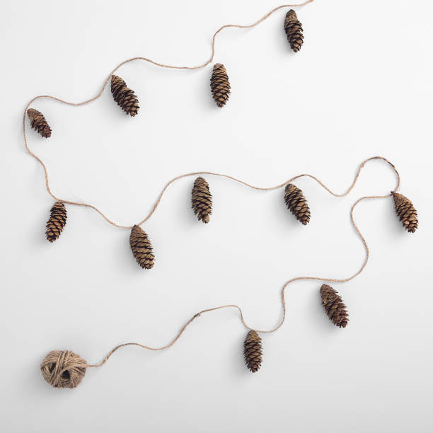 istock Zero waste christmas garland made from pine cone and natural jute twine. Square composition, flat lay, top view. Eco friendly minimal christmas mockup. 1271140495
