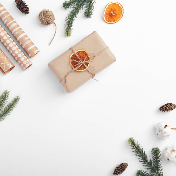 istock Still life with eco material. Craft paper gift with orange 1271140514