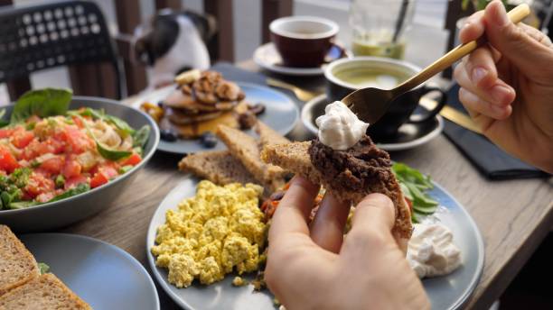 istock Hands spreading dips on piece of brown bread.Healthy balanced vegan brunch 1271142017