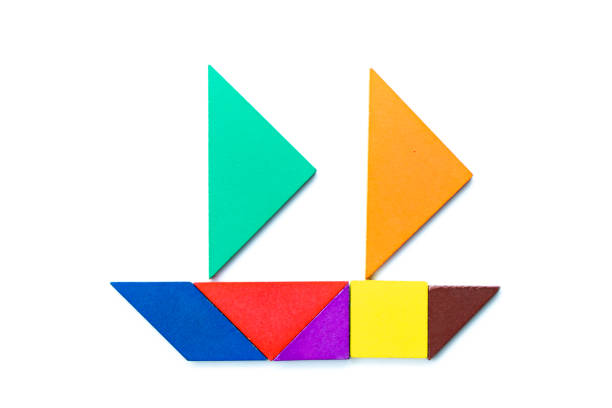 Color wood tangram puzzle in sailing ship shape on white background