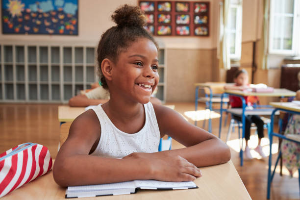 istock Cheerful elementary schoolgirl in a classroom 1271143148