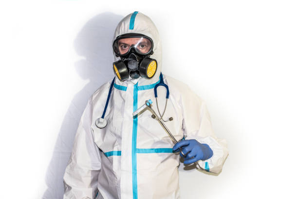 istock doctor with protective suit for covid19 with laboratory equipment White background. 1271143237