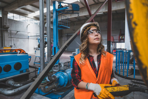 istock Young engineer woman holding and working with remote control for operating crane 1271143838
