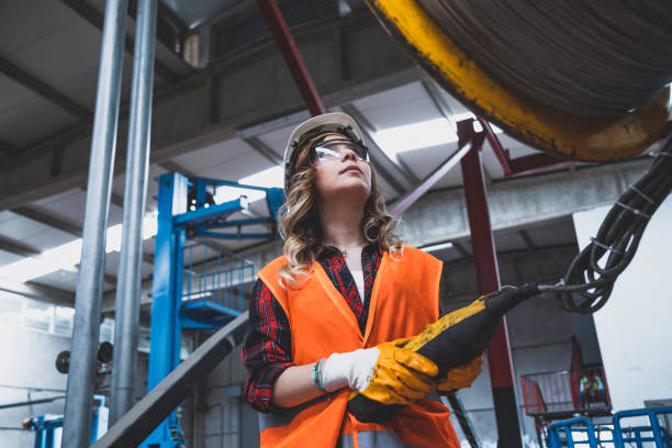 istock Young engineer woman holding and working with remote control for operating crane 1271144455