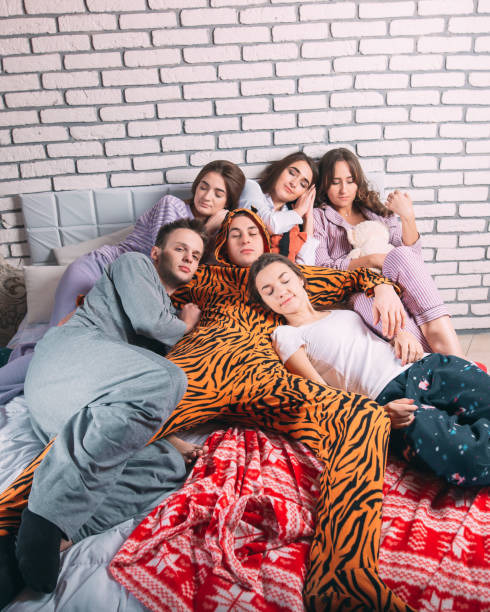 istock Sleeping group of young people on the bed. 1271146231