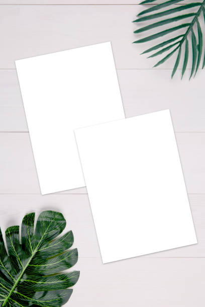 istock Blank paper sheet copy space with mockup and leaf on wooden table, poster and invitation, postcard decoration your design or branding, simplicity and minimal, nobody, flat lay, top view. 1271146397