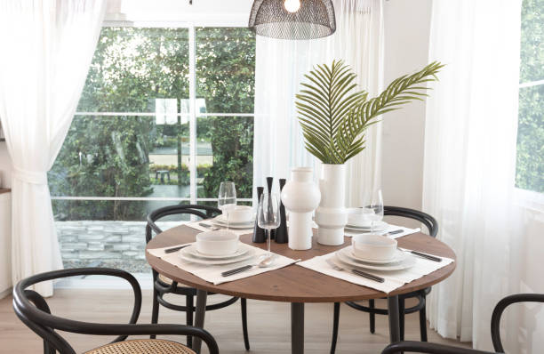istock Modern dining room with a round table and wood chairs. 1271147216