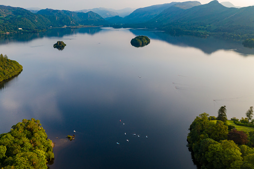 Aerial view of a large, beautiful lake with islands at sunset (Derwent Water, Lake District, England)