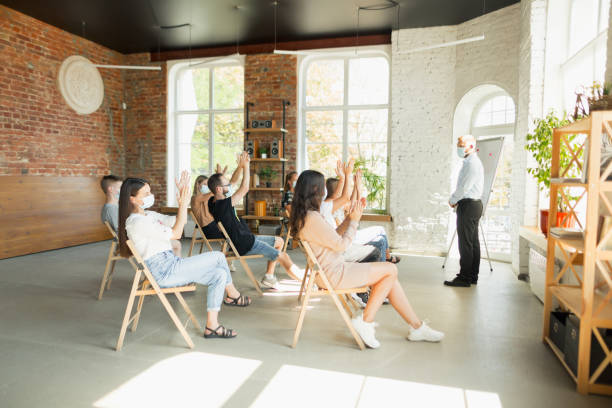 istock Male speaker giving presentation in hall at university workshop. Audience or conference hall 1271148587