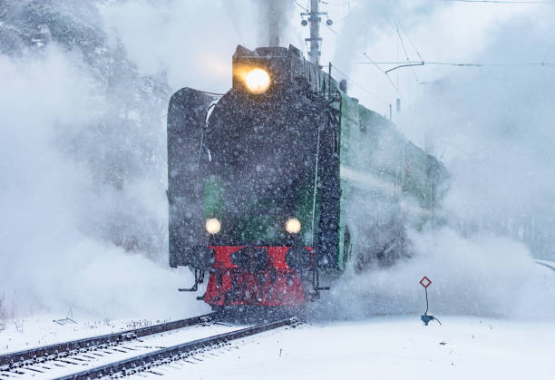 el tren de vapor retro se acerca a la estación de tren. - locomotive steam train train snow fotografías e imágenes de stock