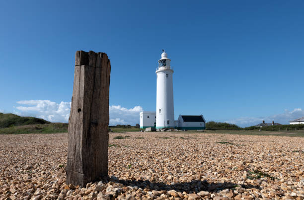 istock Wooden Post and Hurst Point Lighthouse in Hampshire 1271148816