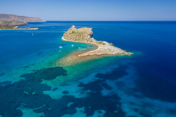 istock Tiny barren island surrounded by a crystal clear tropical Aegean sea (Crete, Greece) 1271149829