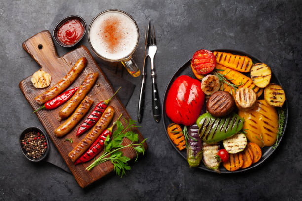 istock Grilled sausages and vegetables with spices and herbs 1271150154