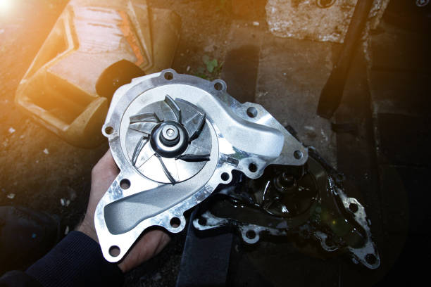 replacement of the car water pump, old and new pumps with metal blades. stock photo