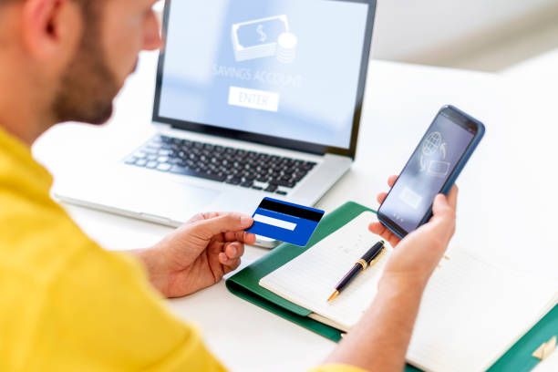 istock Man using bank card and mobile phone transfer money online 1271151556