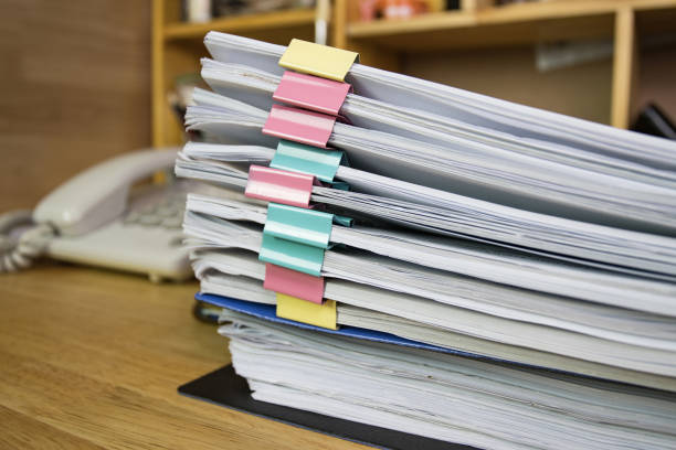 istock file folder and Stack of business report paper file on the table in a work office, concept document in work office 1271151597