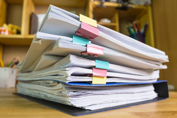 istock file folder and Stack of business report paper file on the table in a work office, concept document in work office 1271151611