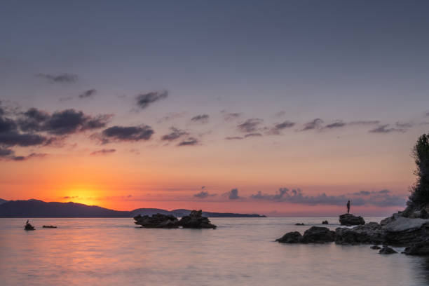 Rocks backlit by the sunset in the Mediterranean Sea, Corsica
