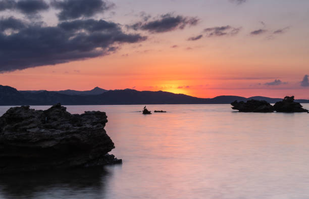 Rocks backlit by the sunset in the Mediterranean Sea, Corsica