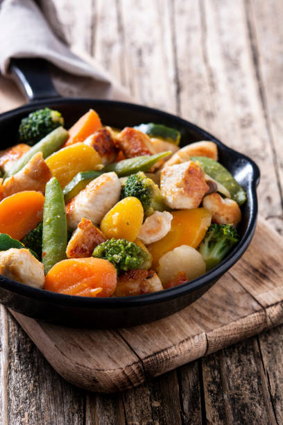 istock Stir fry chicken with vegetables on iron pan 1271156075
