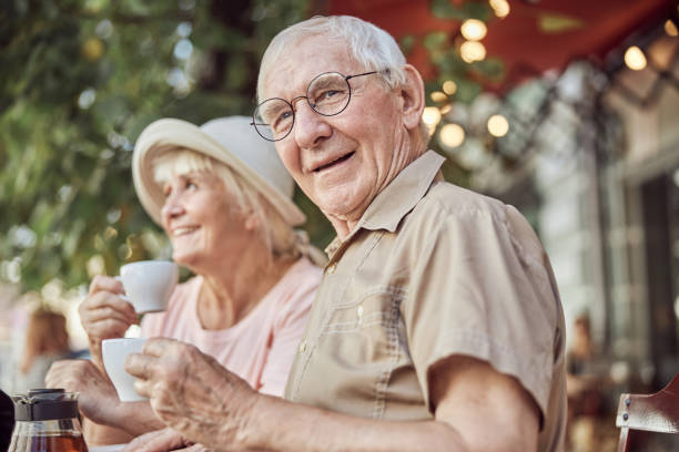 istock Modern elderly couple sitting in an outdoor cafe 1271157971