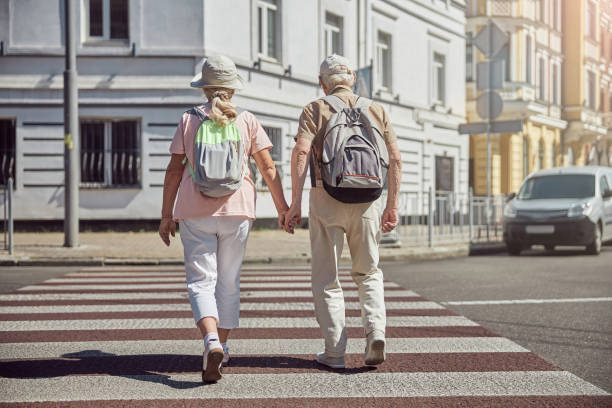 istock Married aged couple walking across the road 1271158042