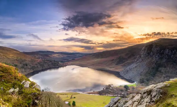 Dramatic sunset at Lake Lough Tay or The Guinness Lake in County Wicklow where Vikings village, Kattegat was located, Wicklow Mountains, Ireland