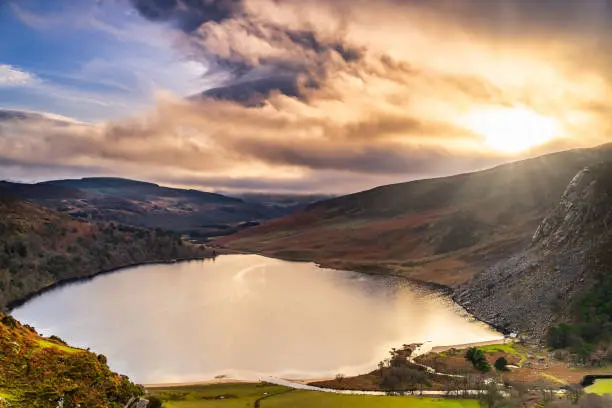 Dramatic sunset at Lake Lough Tay or The Guinness Lake in County Wicklow where Vikings village, Kattegat was located, Wicklow Mountains, Ireland