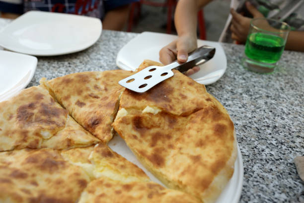 istock Person takes Megrelian Khachapuri from plate 1271161005