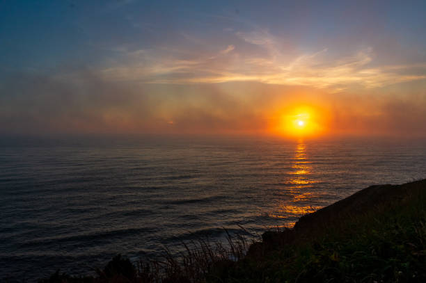 Sunset and fog over Pacific Ocean at Cape Disappointment State Park