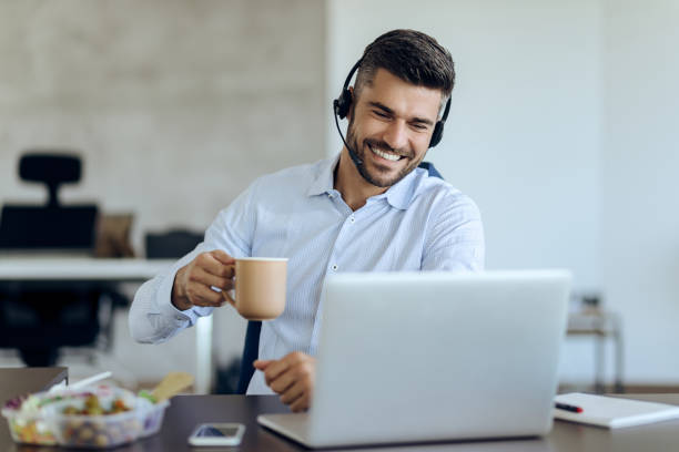 istock Happy businessman making video call while having coffee break in the office. 1271163938